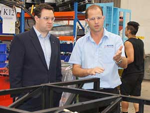 Mr Binns takes the Minister on a factory tour