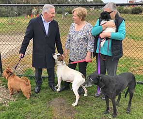 Mr Lucas, Ms Bloomfield (centre) and Albury Wodonga Animal Rescue volunteer Diane with some of the dogs being trained and treated at the rescue centre.