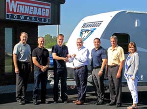 From left: , Winnebago project manager Doug Spencer, Apollo executive manager operations Paul Truman, Mr Trouchet, Towables president Johnny Hernandez, Towables national sales manager Brion Brady, chairman, chief executive and president Randy Potts and VP chief executive Sarah Nielsen.