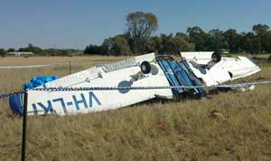 The doomed aircraft rests upside down just metres from the caravan park boundary