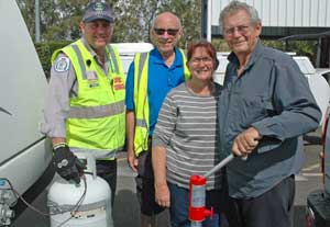 Mr Lamont (second left) with Queensland Transport compliance inspector Tony Aitkon and caravanners